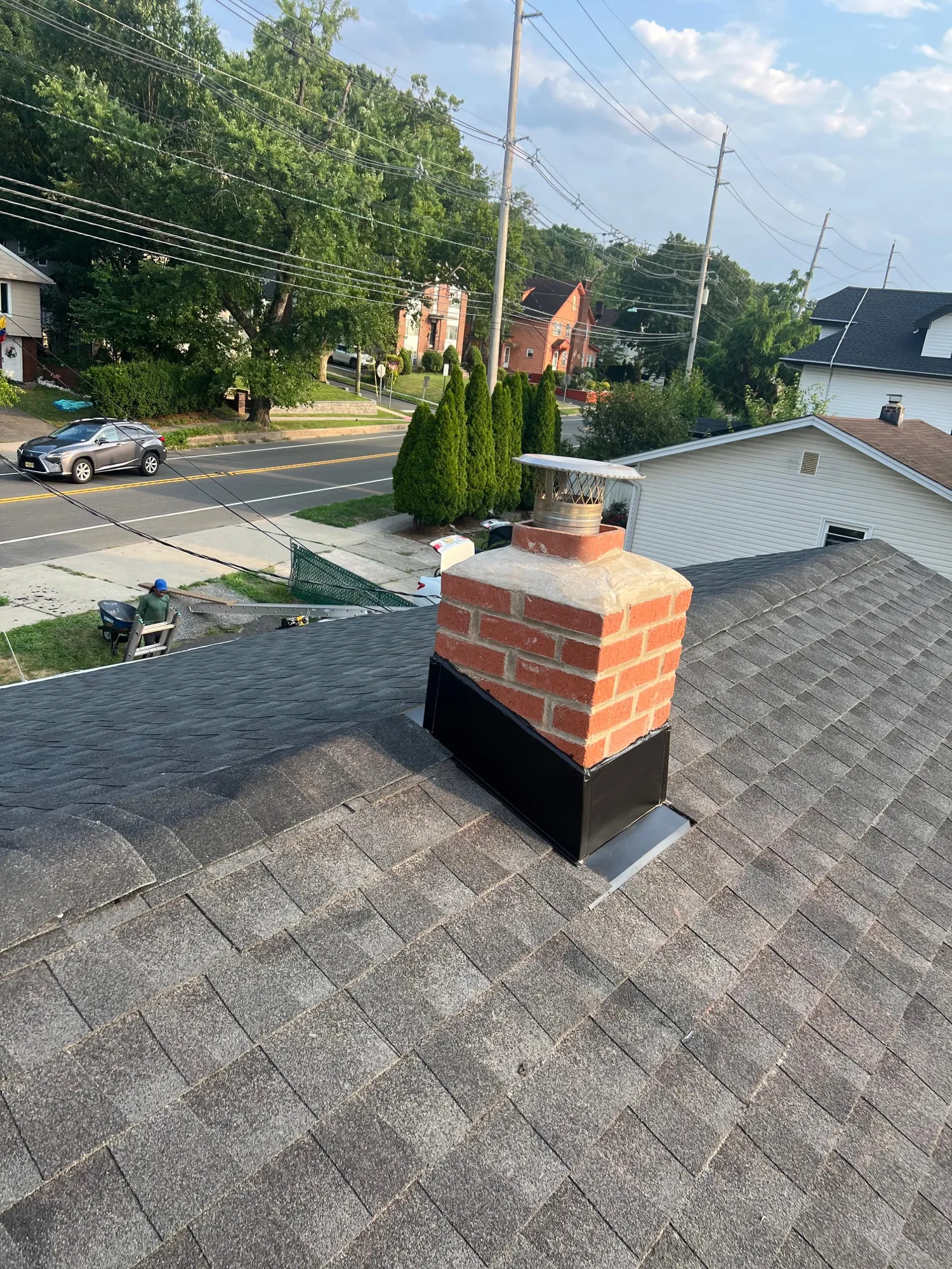 Newly installed brick chimney on a residential roof in New Jersey
