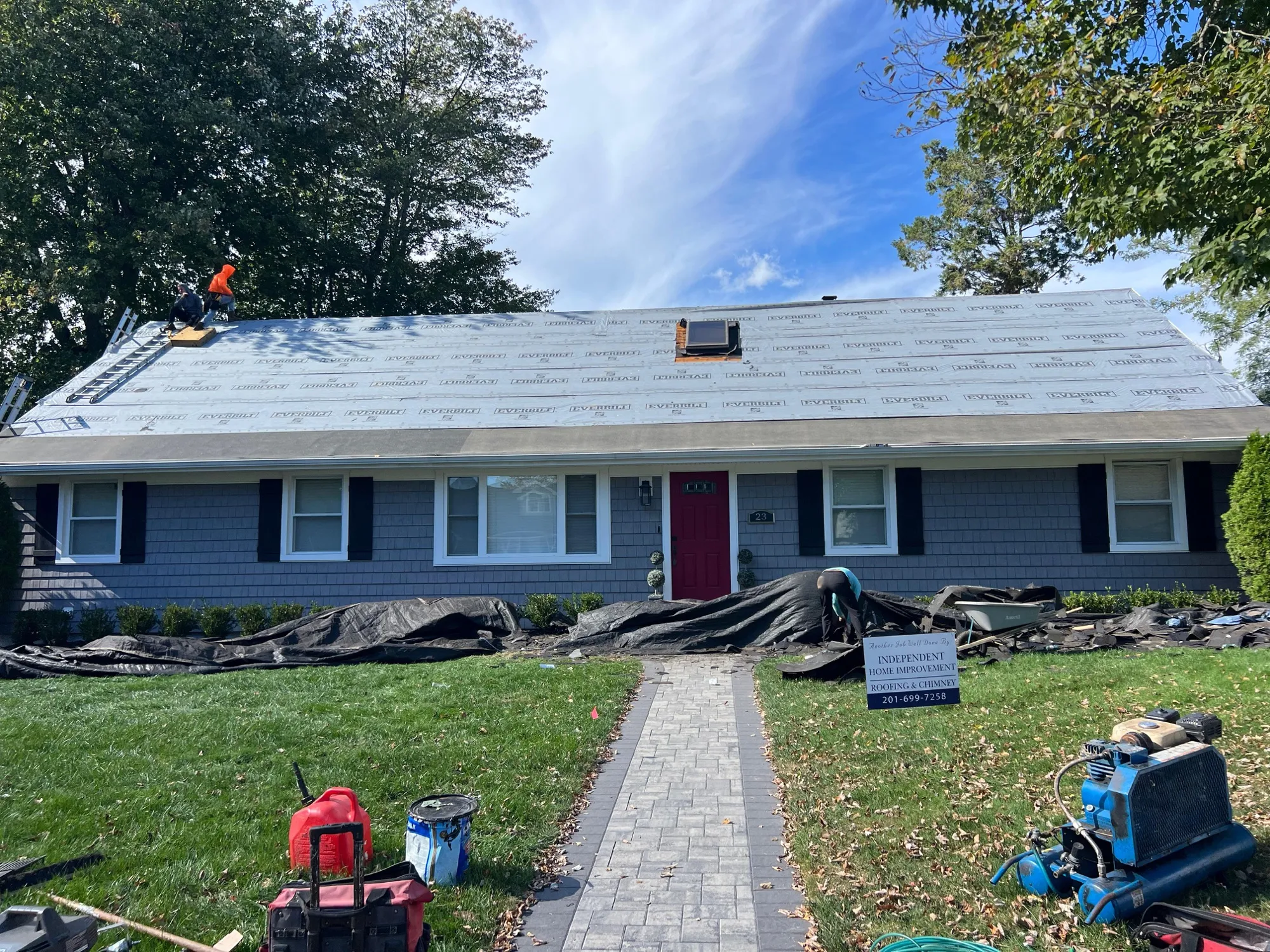 Mid-installation roof project with new shingles being laid